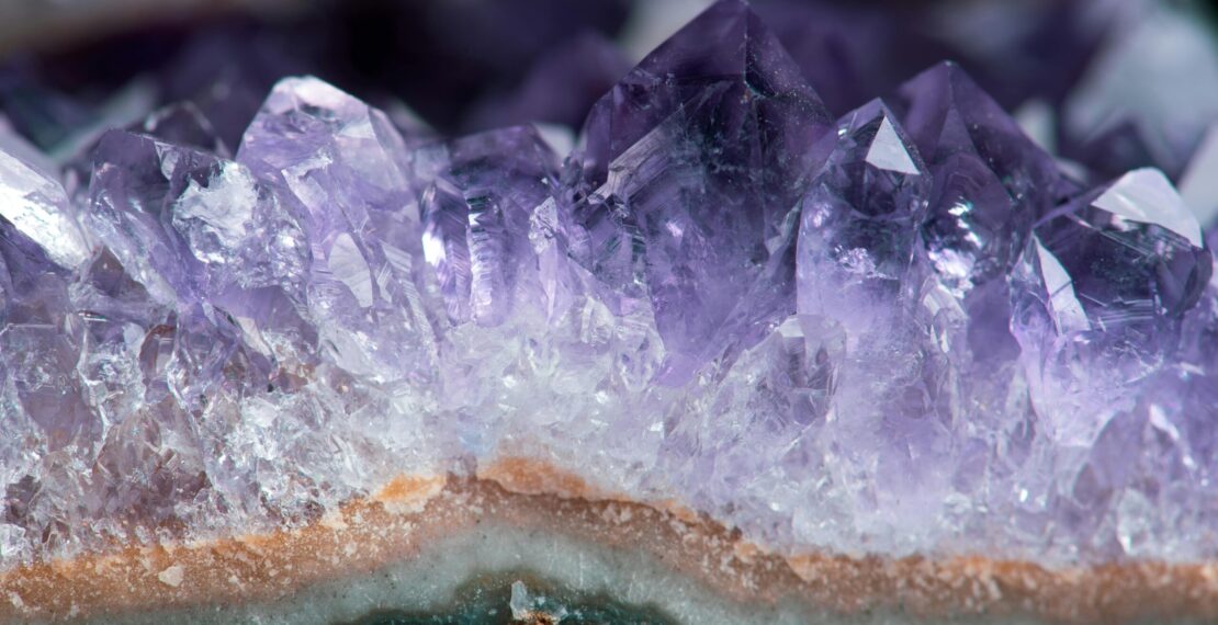 Close-up of beautiful amethyst crystal formations showcasing their vibrant purple hues in stunning detail.